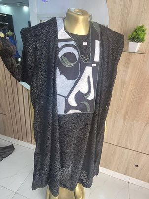 exquisite Agbada ensemble adorned with ancient African image embroidery, paired with sleek trousers and a distinguished Senator style, all crafted from luxurious Turkish lace fabric.
