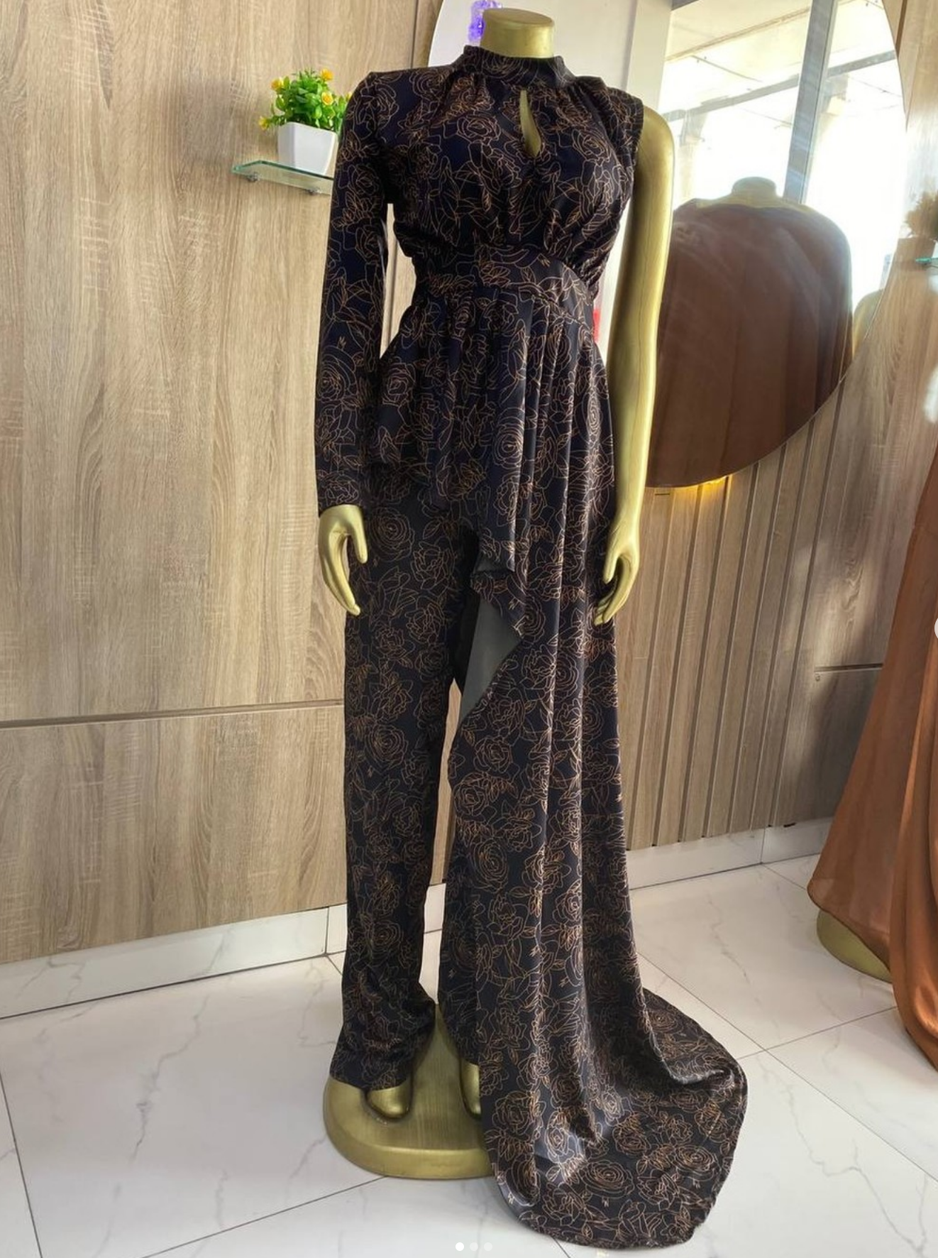 A stunning black crepe two-piece outfit with a bold flowered design