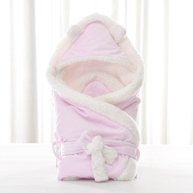 Newborn baby being hugged and swaddled by baby - melvincucci